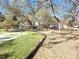 Playground with play equipment, basketball court, and grassy areas at 301 Country Club Way, Venice, FL 34285