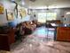 Open floor plan with a living area, kitchen, and metallic epoxy floors at 301 Country Club Way, Venice, FL 34285