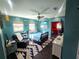 Bedroom with teal walls, a queen bed, and access to a gym at 301 Country Club Way, Venice, FL 34285