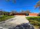 Front view of the property, showcasing the house, driveway, and detached garage at 301 Country Club Way, Venice, FL 34285
