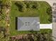 Top down aerial view of a house with a large manicured lawn and tree coverage in a quiet neighborhood at 3705 Baynes Rd, North Port, FL 34288