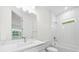 Clean bathroom with white subway tile and a bathtub at 3705 Baynes Rd, North Port, FL 34288