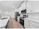 Modern kitchen with white cabinets, stainless steel appliances, and quartz countertops at 3705 Baynes Rd, North Port, FL 34288