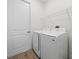 Bright laundry room with washer, dryer, and overhead shelving at 3705 Baynes Rd, North Port, FL 34288