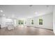 Spacious living area with light wood floors and access to the backyard at 3705 Baynes Rd, North Port, FL 34288
