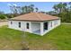 Aerial view of a single story home with a well-maintained backyard and covered patio at 3779 Clearfield St, North Port, FL 34286