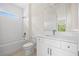 Bathroom features modern fixtures, subway tile and a sunlit window, creating a bright and serene space at 3779 Clearfield St, North Port, FL 34286