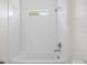 Bathroom showcases an integrated shower and tub, with white subway tile and streamlined fixtures at 3779 Clearfield St, North Port, FL 34286