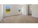 A bright bedroom with wood flooring and large windows with backyard views at 3779 Clearfield St, North Port, FL 34286