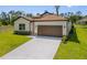 Charming single-story home featuring stone accents, well-manicured lawn, and an attached garage at 3779 Clearfield St, North Port, FL 34286
