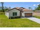 Charming single-story home featuring stone accents, well-manicured lawn, and an attached garage at 3779 Clearfield St, North Port, FL 34286