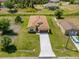 Aerial view of a well-maintained home with a long driveway and landscaped lawn at 3779 Clearfield St, North Port, FL 34286