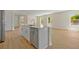 Contemporary kitchen island featuring stainless steel appliances, abundant counter space, and hardwood flooring at 3779 Clearfield St, North Port, FL 34286