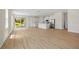 Spacious living room with open floor plan flowing into the kitchen, featuring new flooring and abundant natural light at 3779 Clearfield St, North Port, FL 34286