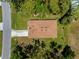 Bird's eye view of the house, displaying its roof, driveway, and the surrounding verdant lawn at 3802 Eagle Pass St, North Port, FL 34286