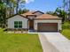 Charming single-story home featuring a well-manicured lawn and a two-car garage at 3802 Eagle Pass St, North Port, FL 34286