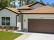 View of the house exterior featuring modern design elements and a well-maintained landscape at 3802 Eagle Pass St, North Port, FL 34286