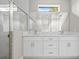 Contemporary bathroom featuring double sinks, quartz countertop, and glass enclosed shower at 3883 Dominic St, North Port, FL 34288