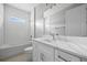 Well-lit bathroom featuring a tub-shower with subway tile and a white vanity with quartz countertop at 3883 Dominic St, North Port, FL 34288