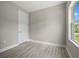 Empty room boasting hard surface flooring, neutral gray walls, and a window for ample natural light at 3883 Dominic St, North Port, FL 34288