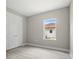 Light-filled bedroom showcasing laminate flooring, gray walls, a double-door closet, and a window at 3883 Dominic St, North Port, FL 34288