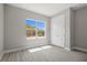 Bedroom showcases light-filled space with a large window and wood-look flooring at 3883 Dominic St, North Port, FL 34288