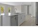 Close-up of the large kitchen island with stainless steel appliances, modern countertops, and neutral color palette at 3883 Dominic St, North Port, FL 34288