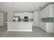Modern kitchen with white cabinetry, stainless steel appliances, a large island, and stylish backsplash at 3883 Dominic St, North Port, FL 34288