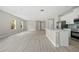 Bright, open-concept living area showcasing a kitchen with modern appliances and ample natural light at 3883 Dominic St, North Port, FL 34288