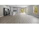 Spacious living room with modern flooring, neutral tones, and abundant natural light from sliding glass doors at 3883 Dominic St, North Port, FL 34288