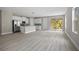 Bright living space with open floor plan showcasing the modern kitchen and access to the outdoor patio at 3883 Dominic St, North Port, FL 34288