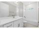 Bathroom with white vanity, bathtub, and subway tile at 3885 Eagle Pass St, North Port, FL 34286