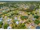 An aerial view of a charming community with lush landscaping, serene waterways, and beautiful homes at 4131 Bula Ln, North Port, FL 34287