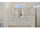 Bright bathroom featuring double vanity, marble countertops, subway tile, and glass-enclosed shower at 4131 Bula Ln, North Port, FL 34287