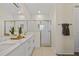 Modern bathroom features double vanity, glass enclosed shower, and stylish white subway tile at 4131 Bula Ln, North Port, FL 34287