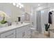 Bathroom showcasing vanity, subway tile, tub/shower combo and decorative accents at 4131 Bula Ln, North Port, FL 34287