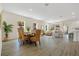 Bright, open-concept dining room with natural light and stylish wicker chairs at 4131 Bula Ln, North Port, FL 34287