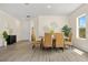 Open-concept dining area featuring wicker chairs and modern decor, adjacent to the entryway at 4131 Bula Ln, North Port, FL 34287