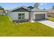 Charming single-story home with a gray roof, two-car garage, fresh lawn, and stylish landscaping at 4131 Bula Ln, North Port, FL 34287