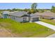 The exterior shows manicured lawn with an attached garage, stone accents, and a driveway at 4131 Bula Ln, North Port, FL 34287
