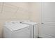 Laundry room features newer appliances, shelving for supplies, and a bright, clean space at 4131 Bula Ln, North Port, FL 34287