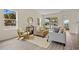 Bright living room features modern decor, neutral tones, and sliding glass doors to the outdoor living space at 4131 Bula Ln, North Port, FL 34287