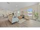 Inviting living room with ample seating, woven accents, and an open dining area at 4131 Bula Ln, North Port, FL 34287