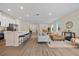 Open-concept living area with a large kitchen island, dining area, and stylish living room furniture at 4131 Bula Ln, North Port, FL 34287