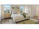 Serene main bedroom with natural light, neutral décor, and a plush bed with decorative pillows at 4131 Bula Ln, North Port, FL 34287