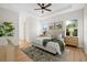 Spacious bedroom features a tray ceiling, ceiling fan and en-suite bathroom entrance at 4637 Irdell Ter, North Port, FL 34288