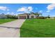 Inviting home featuring a well-maintained lawn, extended driveway, and a welcoming facade at 4637 Irdell Ter, North Port, FL 34288