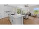 Open concept view of the kitchen and living room area with lots of natural light and stainless appliances at 4637 Irdell Ter, North Port, FL 34288