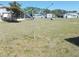 Expansive backyard featuring a rotary clothesline, perfect for outdoor drying at 5524 Holiday Park Blvd, North Port, FL 34287