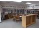 Spacious library area with bookshelves, tables, and chairs offering an inviting space for reading and learning at 5524 Holiday Park Blvd, North Port, FL 34287